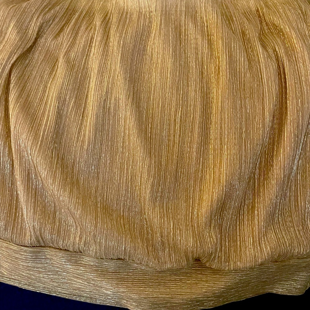 Shimmery gold strapless top.